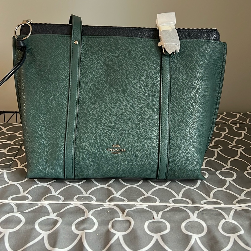 Brand new, with tags, coach leather bag.  Dark teal with navy accents.